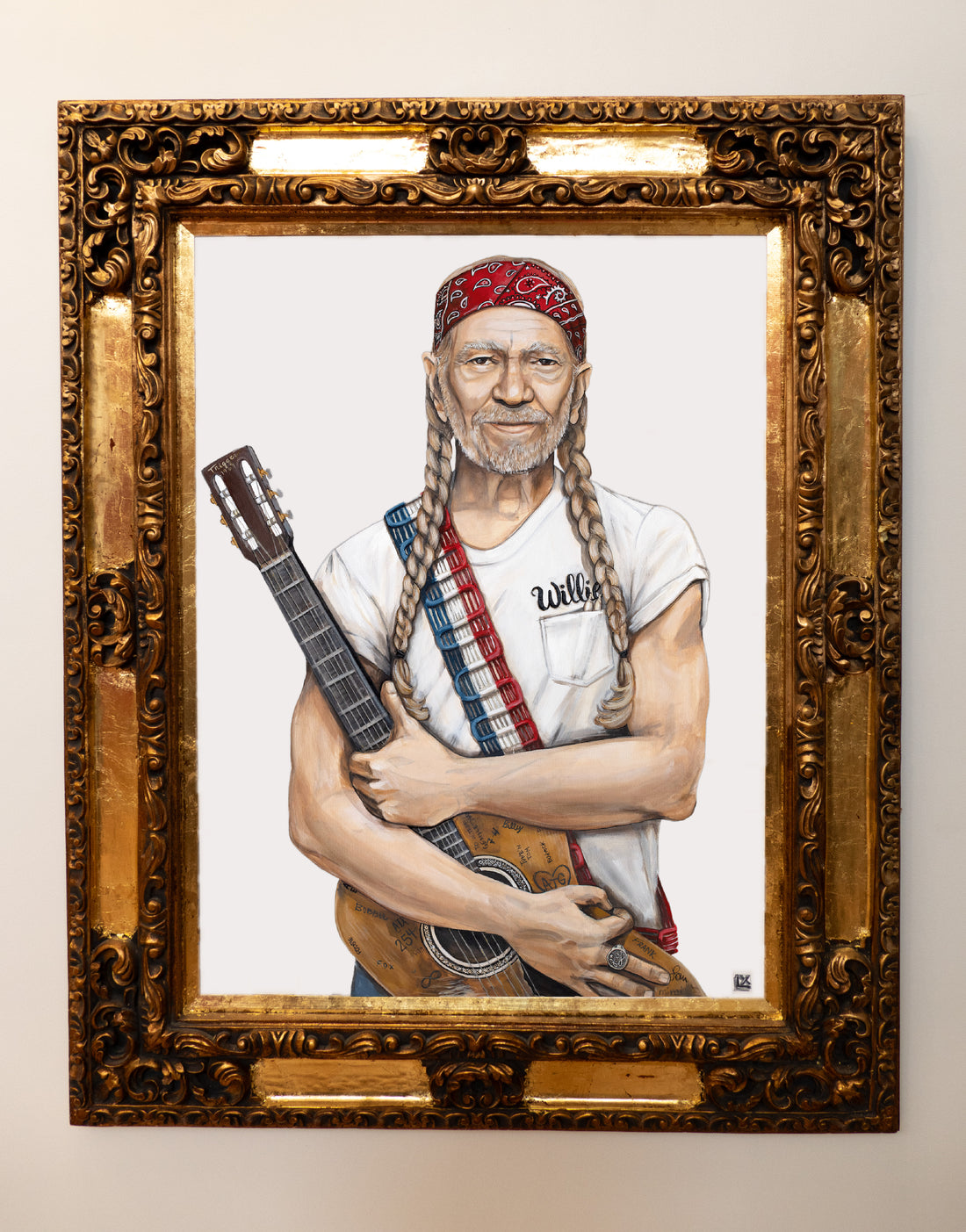 Framed painting of Willie Nelson wearing red white and blue holding guitar