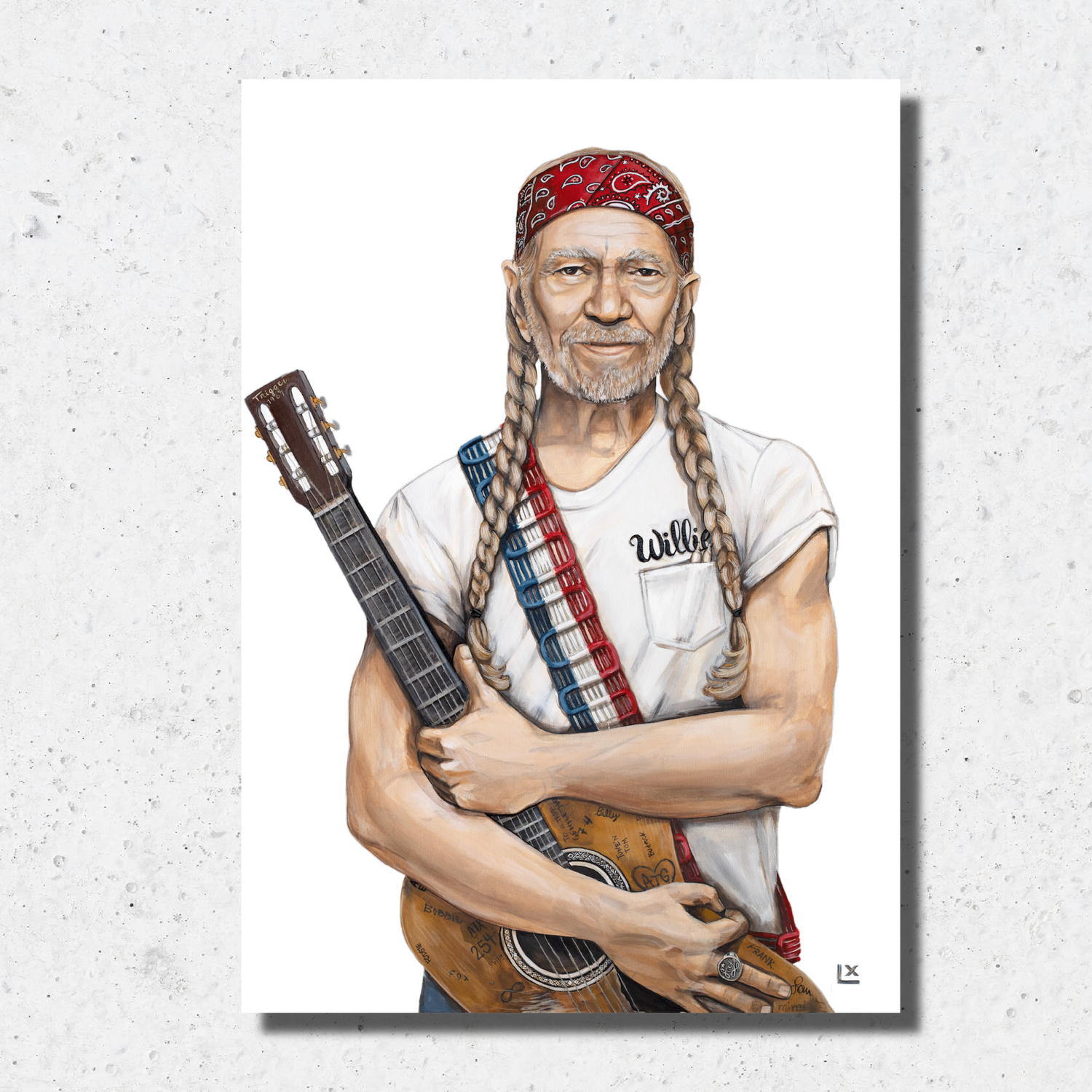 Paper print of Willie Nelson wearing red white and blue with guitar
