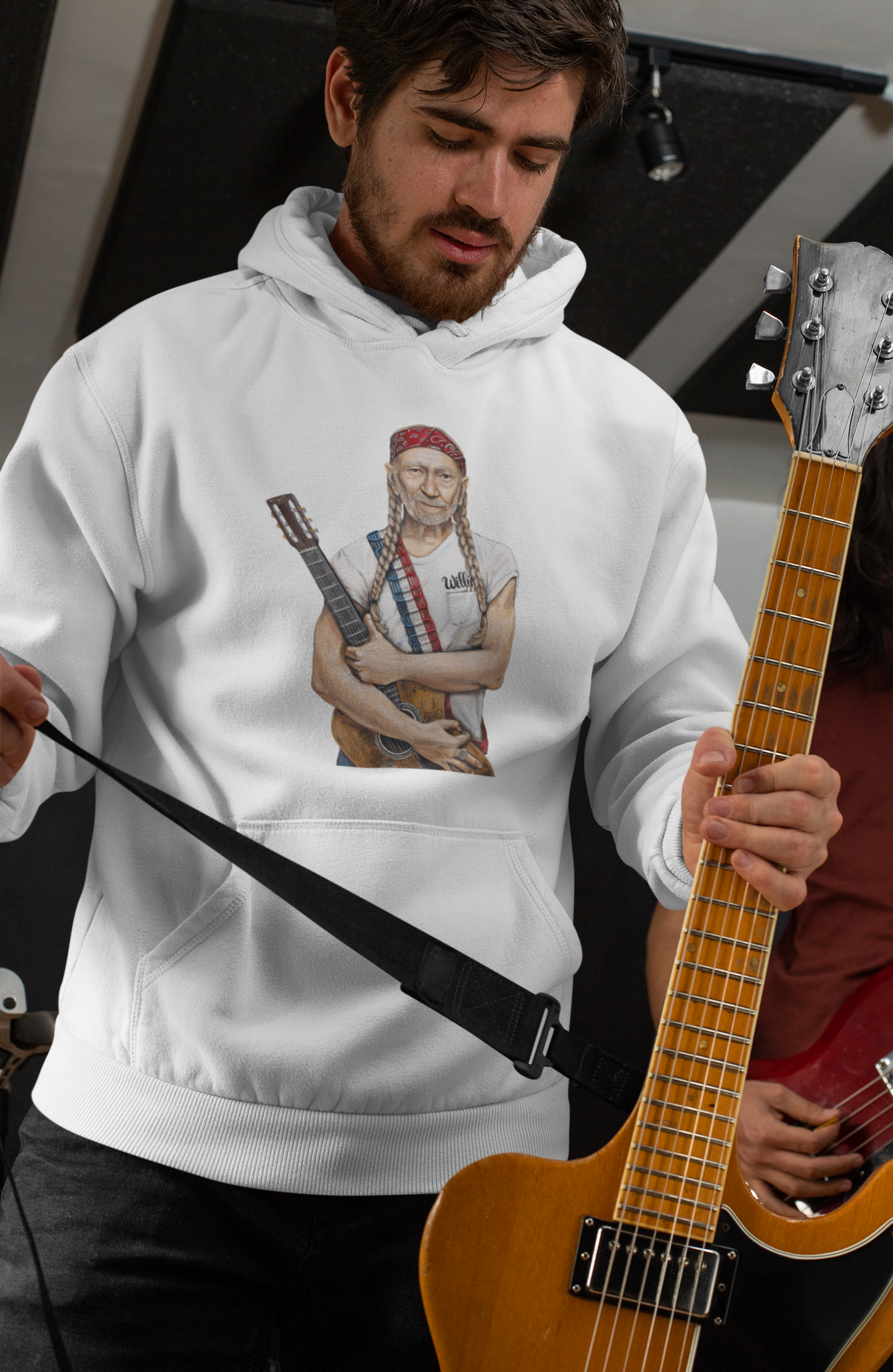 Sweatshirt featuring Willie Nelson wearing red white and blue with guitar